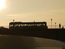 silhouettes of people on the bridge