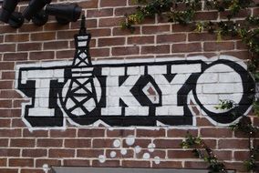 tokyo graffiti on a brick wall