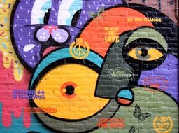 eyes and faces, colorful graffiti on the wall