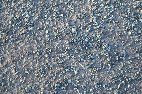 pebbles on asphalt road close up