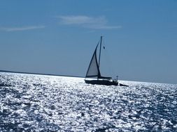 sailboat on shiny water