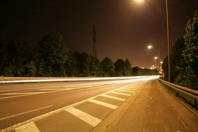 traffic lights above asphalt road, long exposure