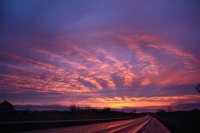 sunset, purple sky with pink clouds above road