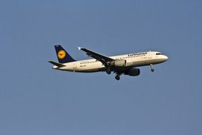 an airplane is flying in the blue sky