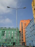 high support street lighting on the background of colorful facades of houses