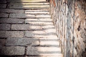 Light and shadow on a stone road