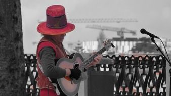 street musician plays guitar