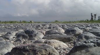 stones on the road near the field