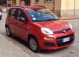 red small fiat on city street