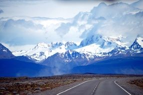 view from the highway to the snow-capped mountains of Patagonia