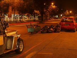 homeless person with trash bags on street in city