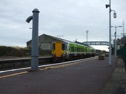 passenger train at railway station, uk, ireland