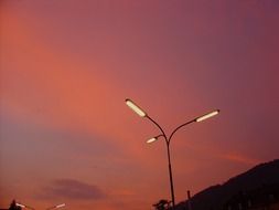 street lamp against the red sky