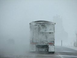 truck on the road in a blizzard