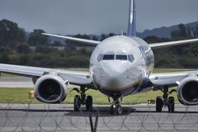 plane on the runway near the fence, uk, england, manchester