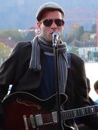 street musician plays the guitar