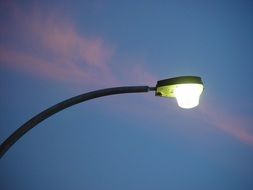 bright street lamp on sunset background