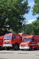 variety of fire trucks near the road on a sunny day