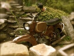 old motorcycle near the stones in a blurred background
