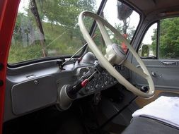 steering wheel of a bright vintage fire engine close up