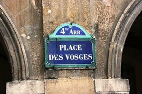 street sign on a wall in paris