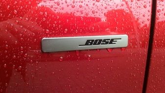 bose as a logo on a red car closeup