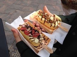 two ice cream desserts on hands