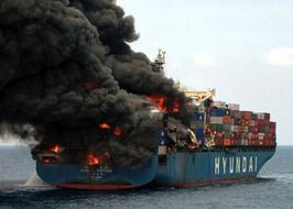 Burning ship with black smoke