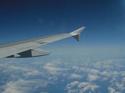 wing of the airplane above the clouds