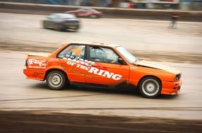 orange race car on the track