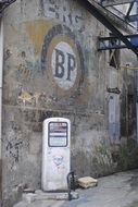 old fuel pump near the stone wall