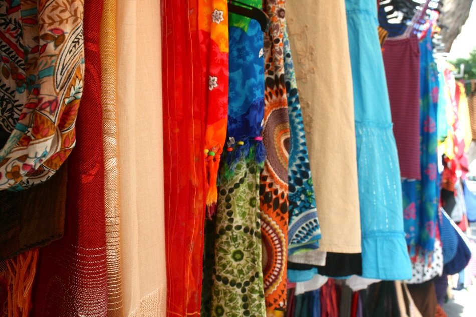 selling colorful clothes on the market in Spain