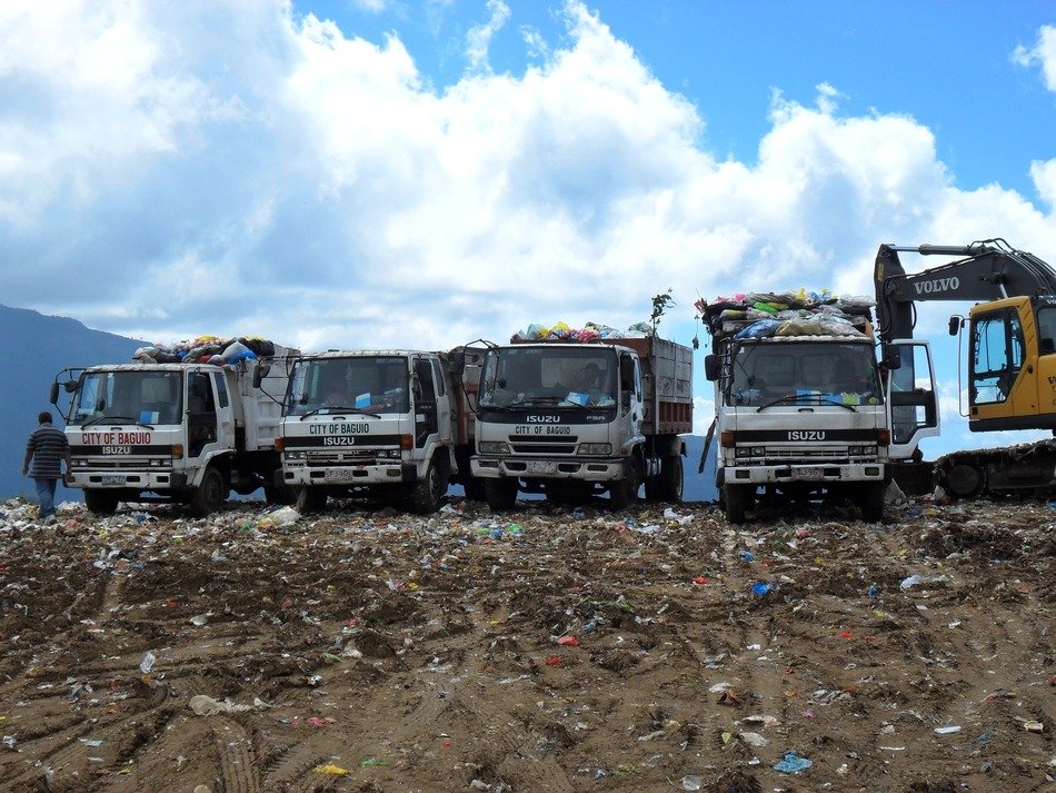 trucks with garbage at the dump