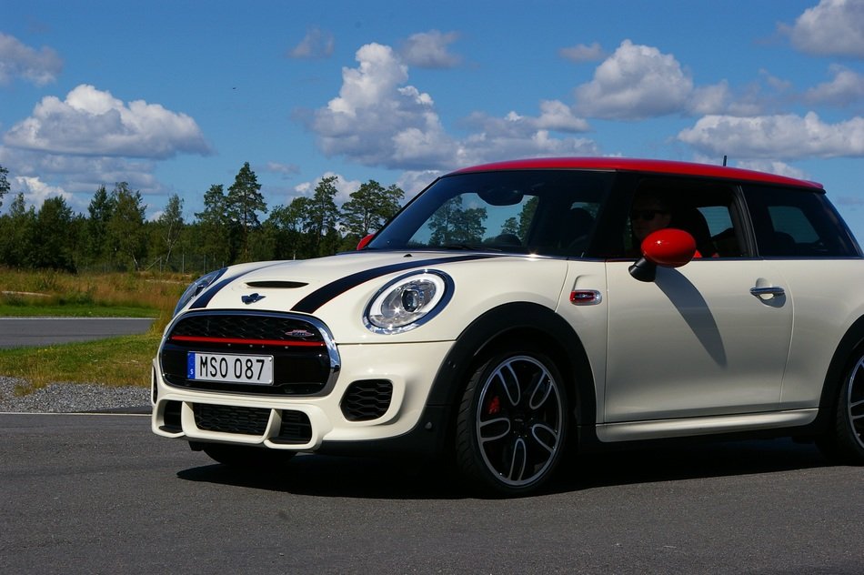 new white and red minicooper car on road