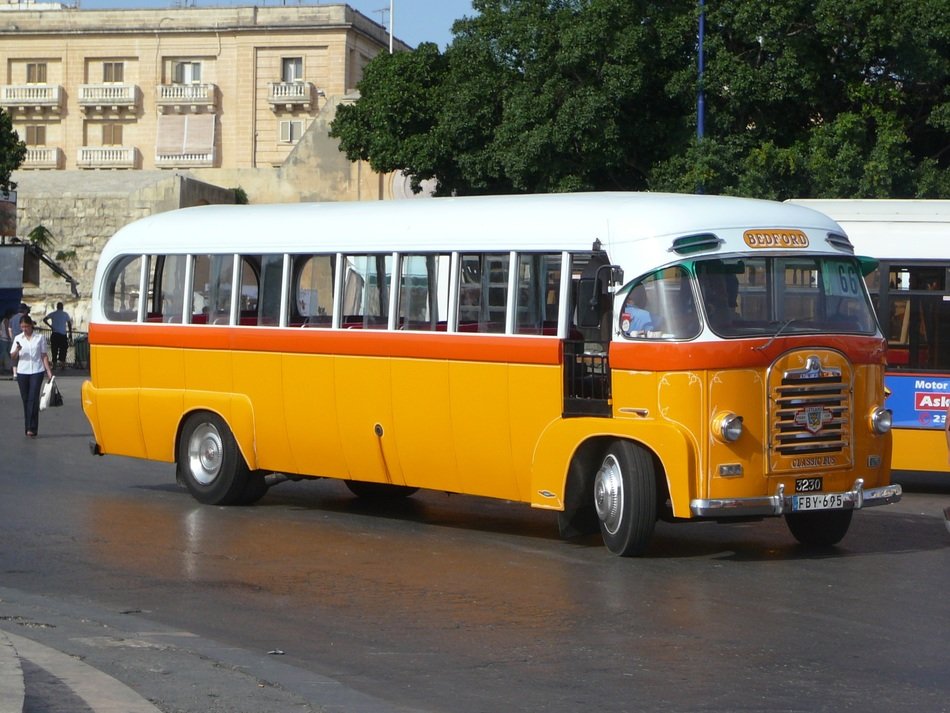 yellow vintage bus on a city street