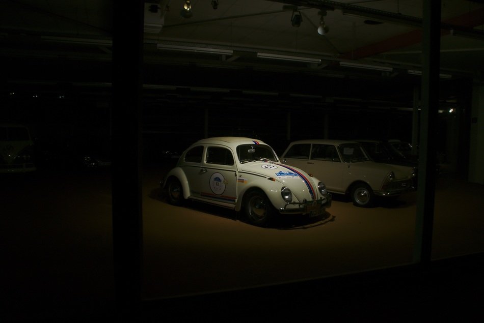 white retro volzwagen beetle at dusk