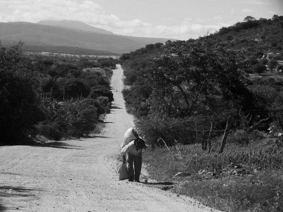 man with a load on the road in black and white image