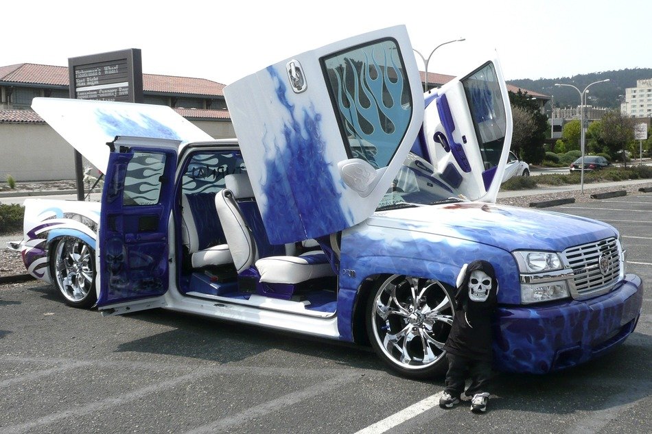 blue and white crazy car with raised doors