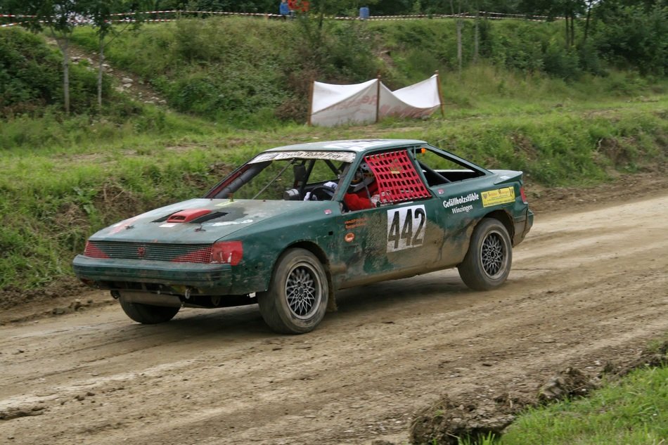 green racing car on the track