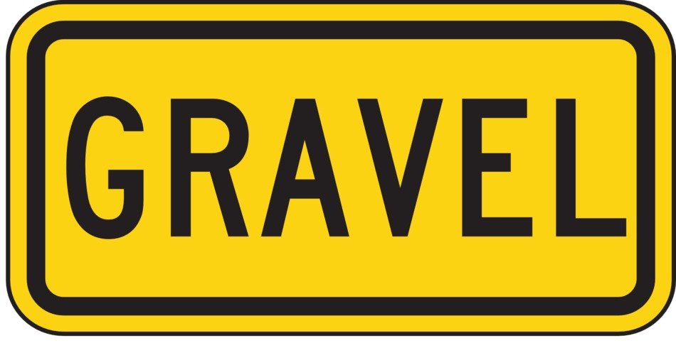 yellow road sign warning about gravel