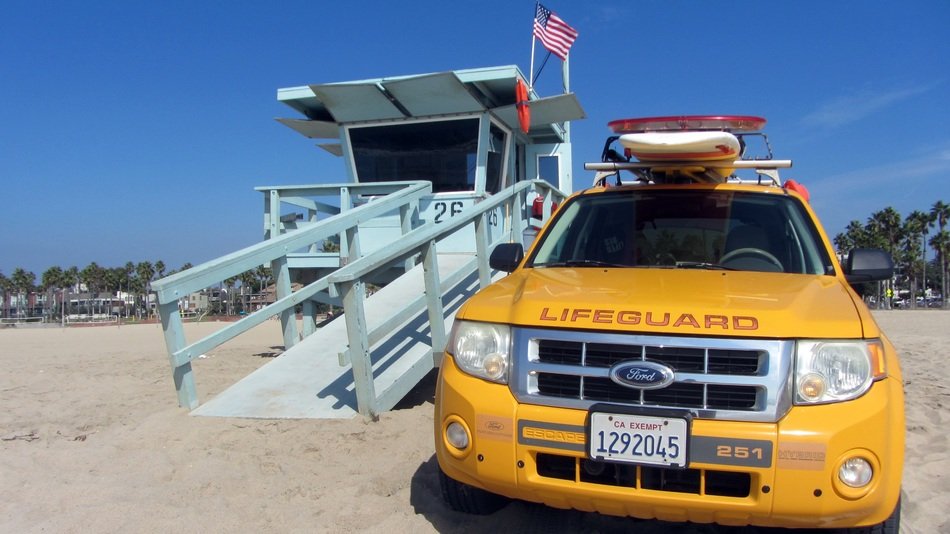 yellow lifeguard car on the beach in Venice