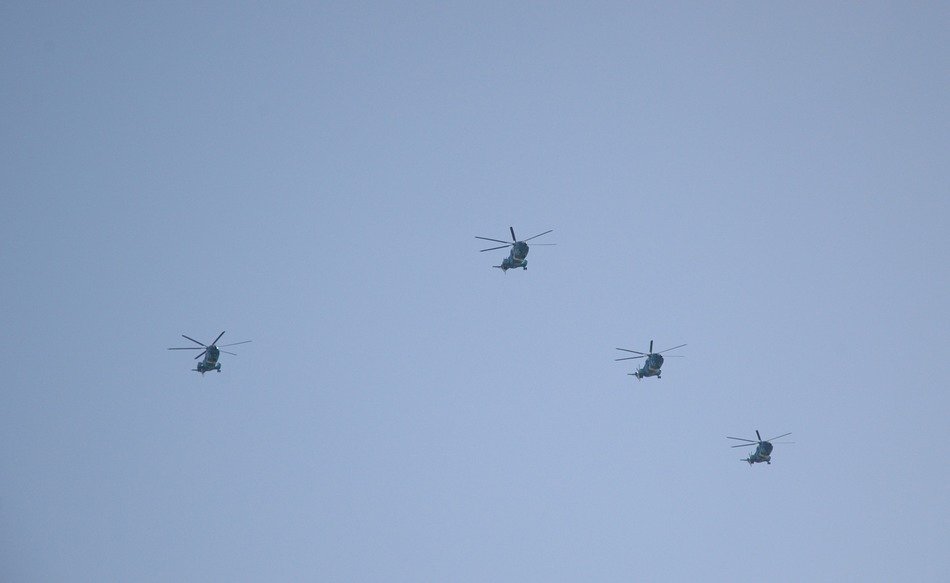 four distant helicopters at sky