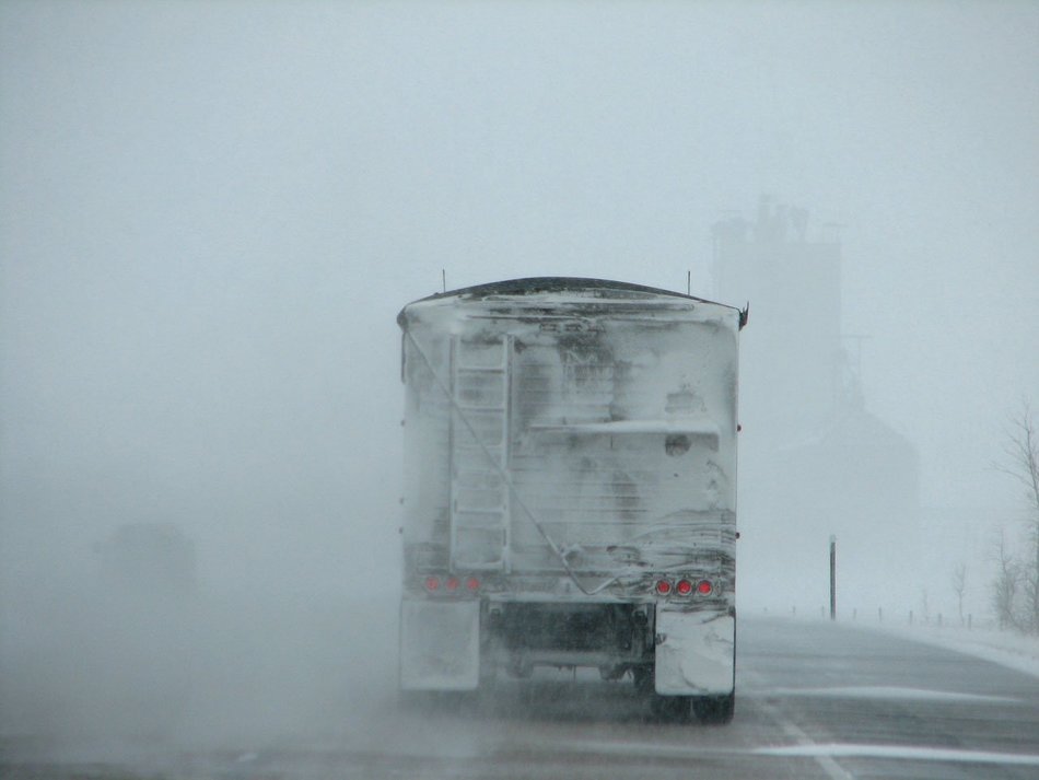 truck on the road in a blizzard
