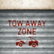 weathered garage roll-up sheet door with airbrushed tow away icon vector N2