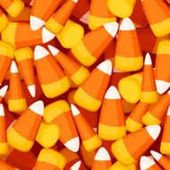 Seamless background with candy corn Vector illustration