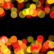 blurred warm tone dots on black background N5
