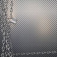 Metal chain and padlock on gray metal background with perforated texture