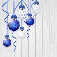 Blue Christmas balls and tinsel on wooden background