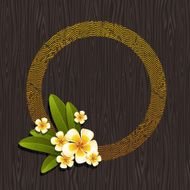 Round frame &amp; tropical flowers on a wood background