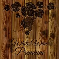 Bunch of grapes graven on a wood plank background